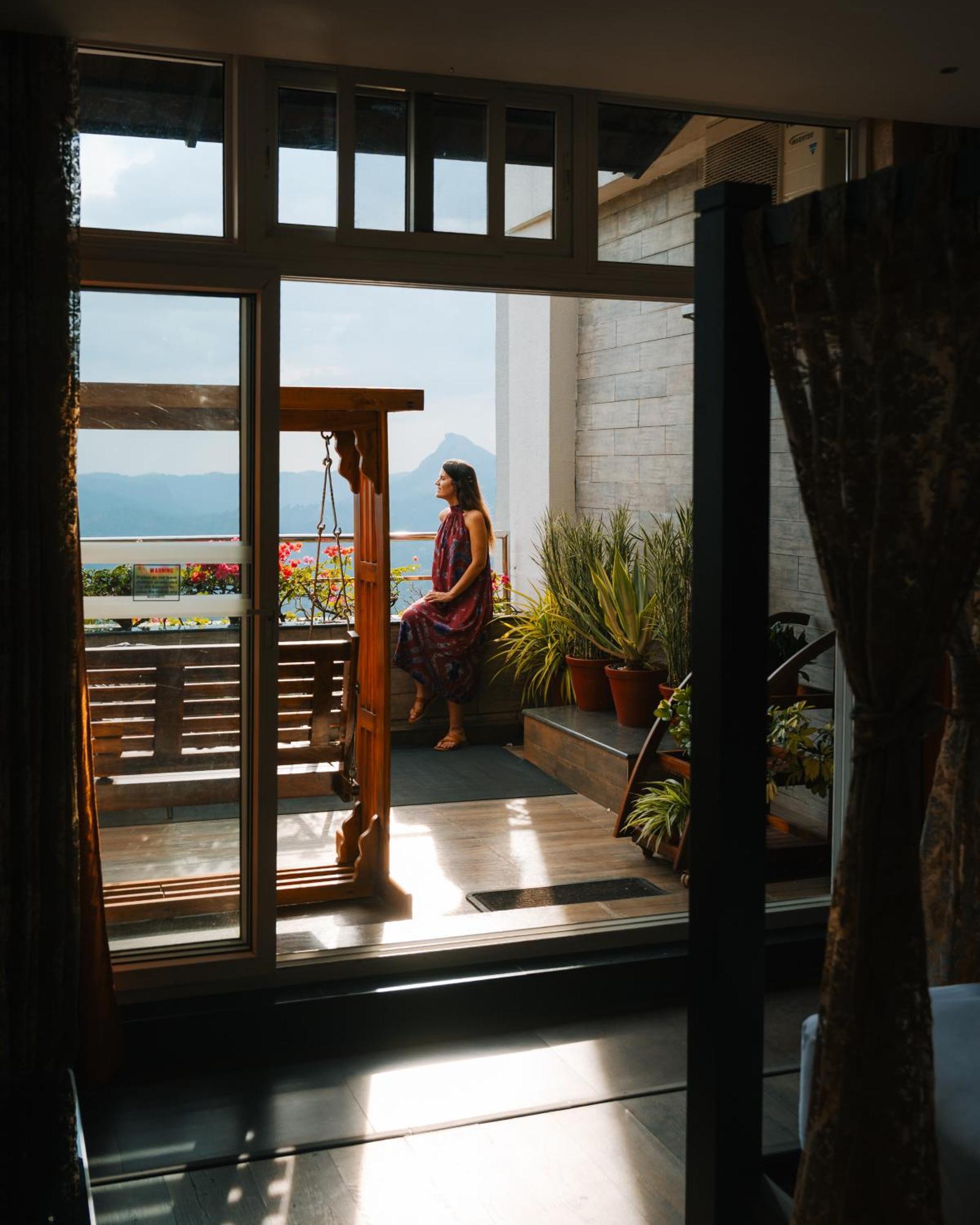 The Panoramic Getaway Hotel Munnar Exterior foto A woman on a balcony